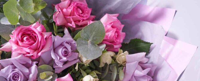 Close-up of a colorful bouquet of flowers. Big pink roses. On a light background, top view, copy space. High quality photo